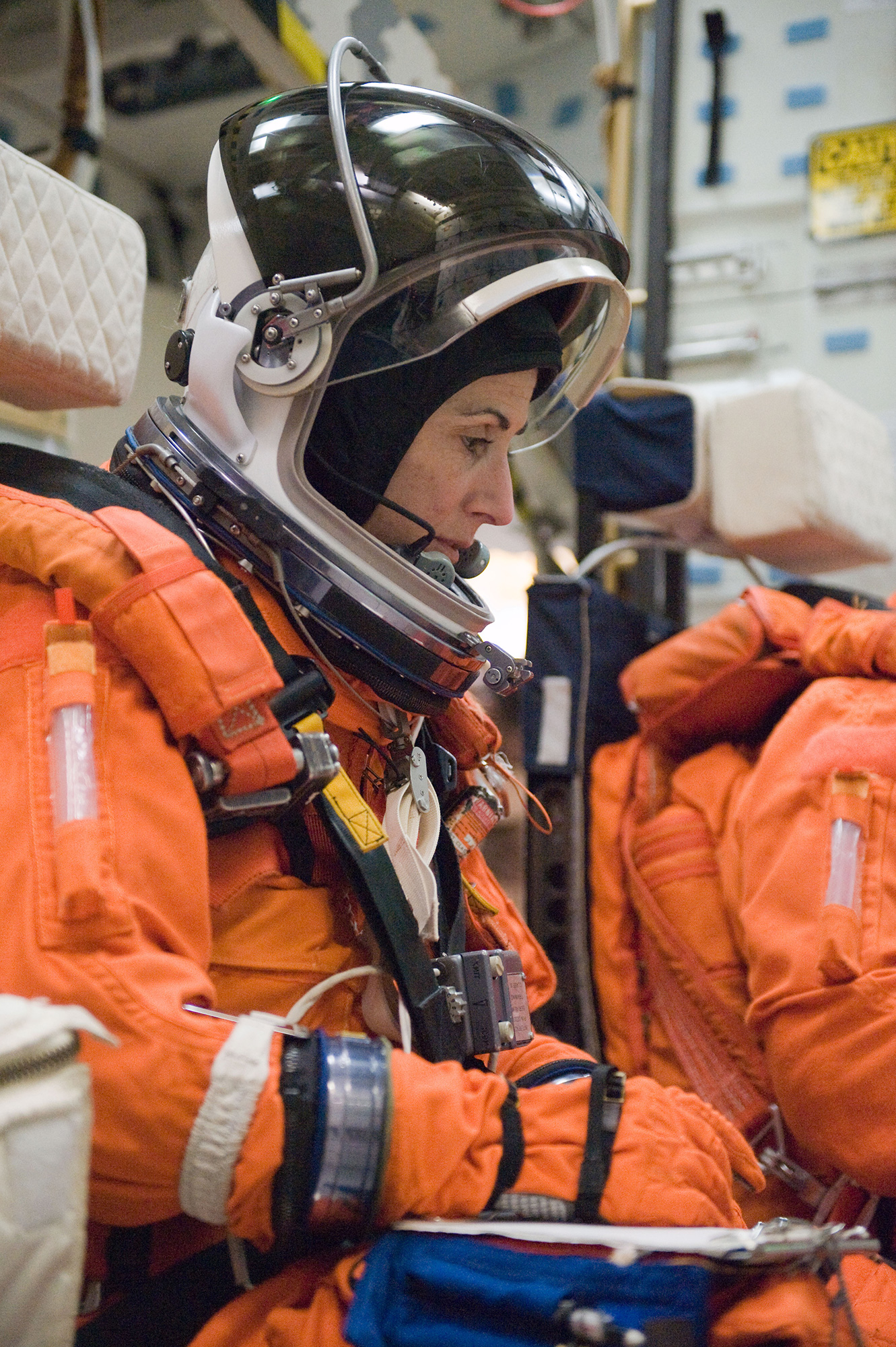 NASA astronaut Nicole Stott, STS-133 mission specialist, participates in a post insertion/de-orbit training session on the mid-deck of the crew compartment trainer in the Space Vehicle Mockup Facility at NASA's Johnson Space Center, 23 March 2010. Stott is wearing a training version of her shuttle launch and entry suit. Credit: NASA