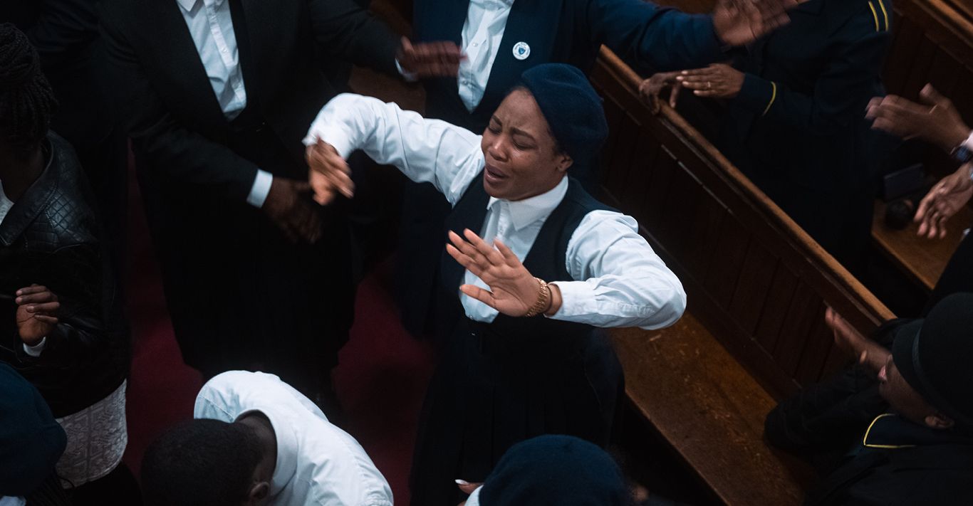 Members of the congregation at City Mission Church engage in a theatrical display of worship