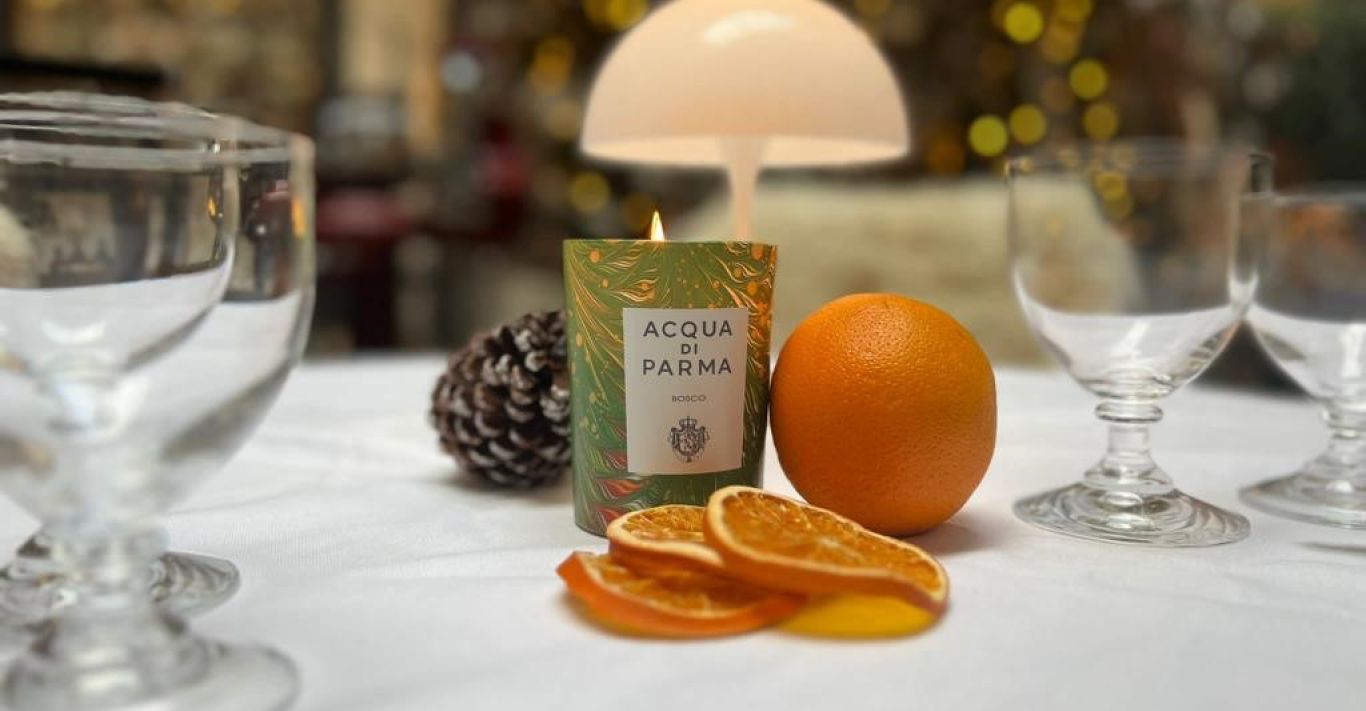 Acqua di Parma's seasonal exclusive candle burns, permeating Corinthia London's festive interior with the Bosco scent