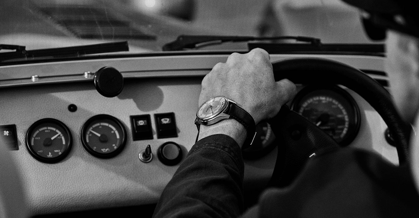 Photographer Adam Whitehead's wrist adorned with Reservoir’s classically-inspired motoring watch, the Kanister Silver