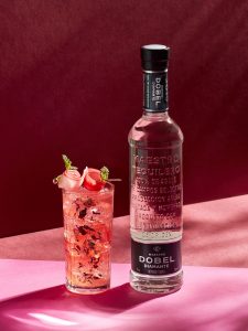 Hibiscus highball cocktail and a bottle of Maestro Dobel Diamante Reposado Tequila