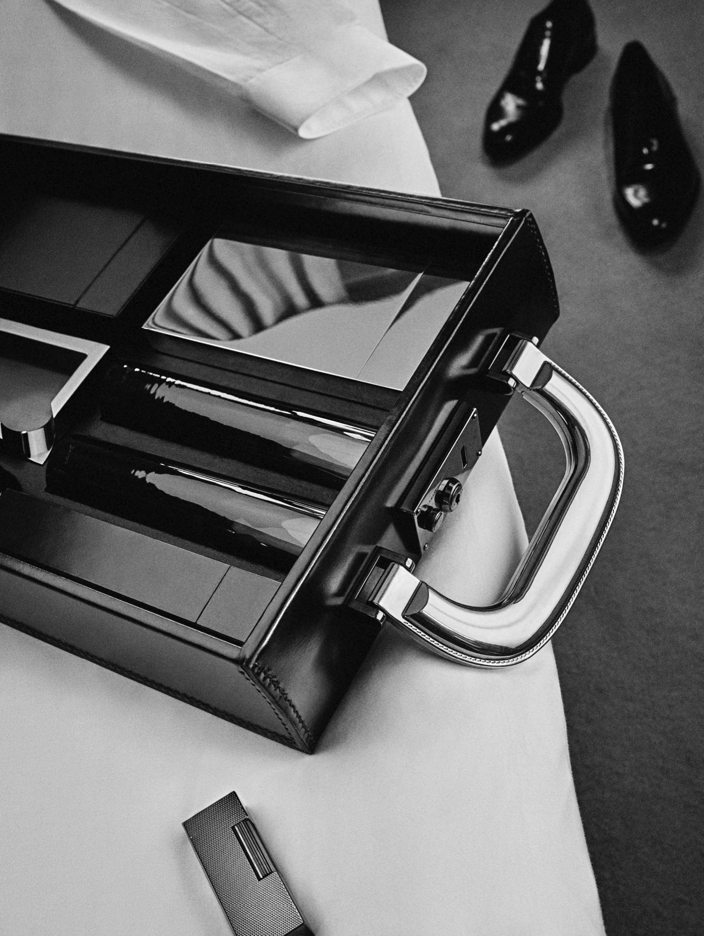 (From the bottom) The incense case, handmade shot glasses, and silver-plated flask. Lying beside the attaché is the Black Rollagas Barley Lighter