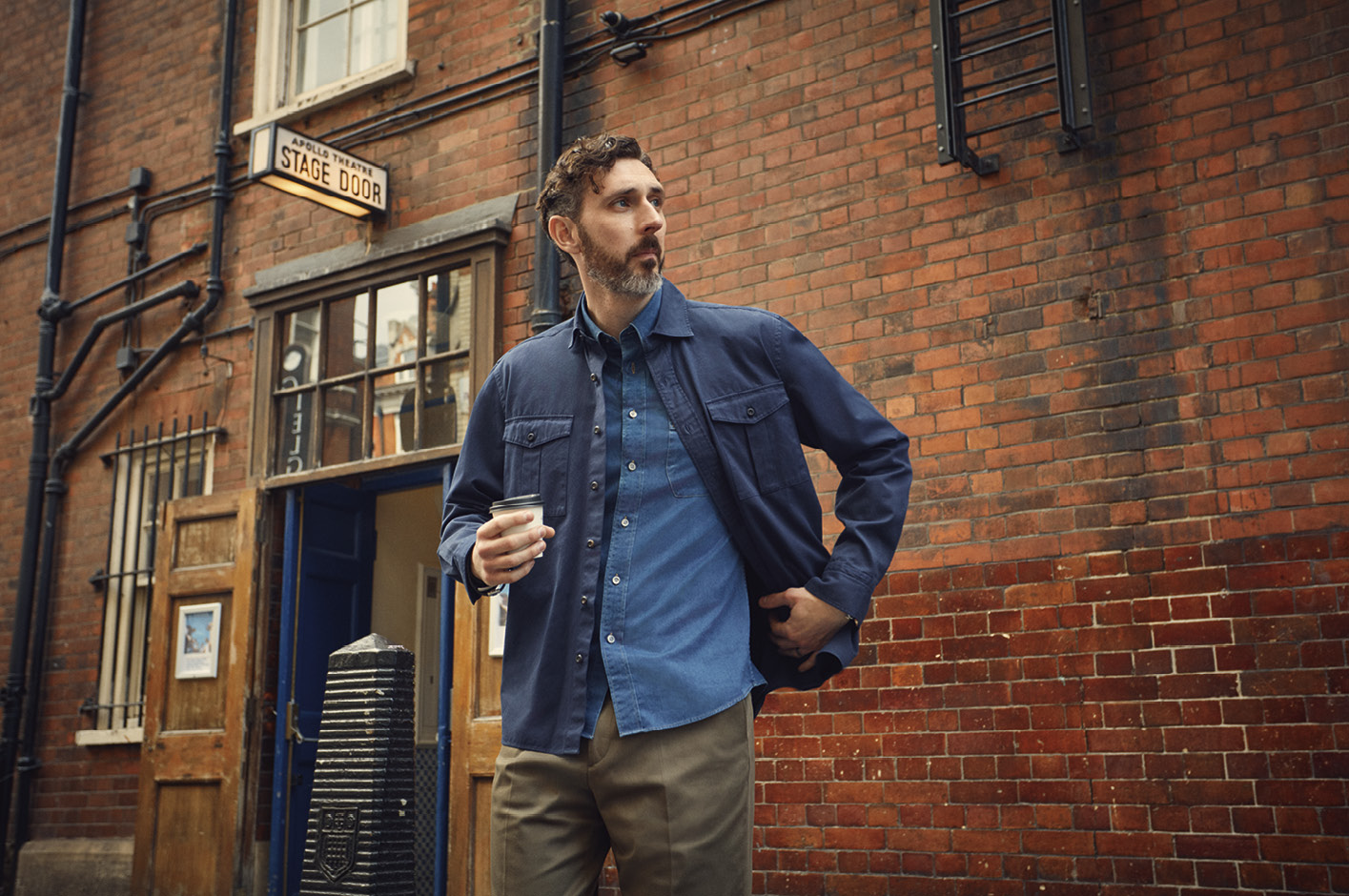 Blake wears loose fit garment dye Utility shirt, £125, with tailored fit smart casual Indigo fine twill shirt, £95, worn underneath