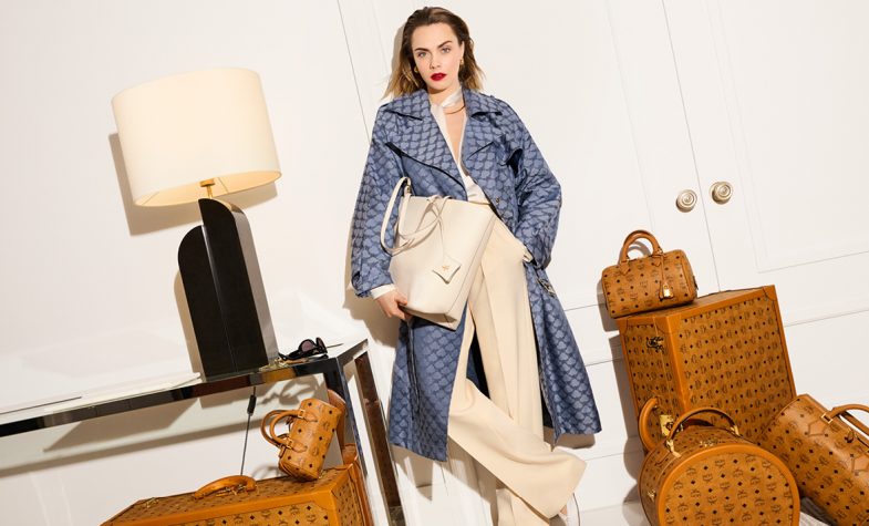 Cara Delevingne is the face of the latest MCM campaign, which includes bags, shoes, knitwear, varsity jacket and a Lauretos monogram trench coat
