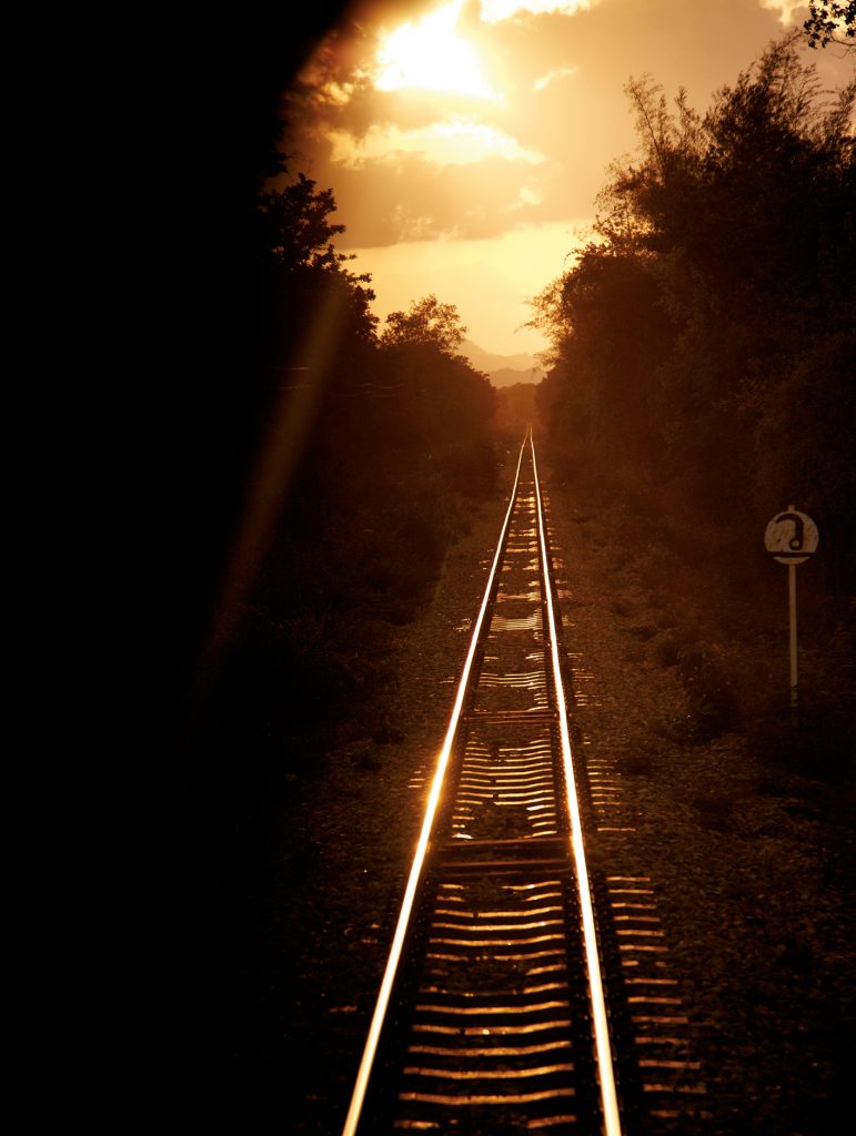 Train track towards sunrise