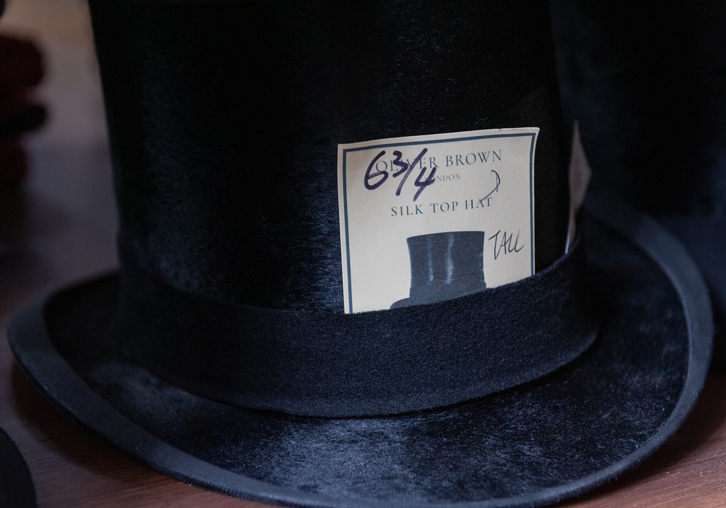 One of Oliver Brown's signature antique silk top hats