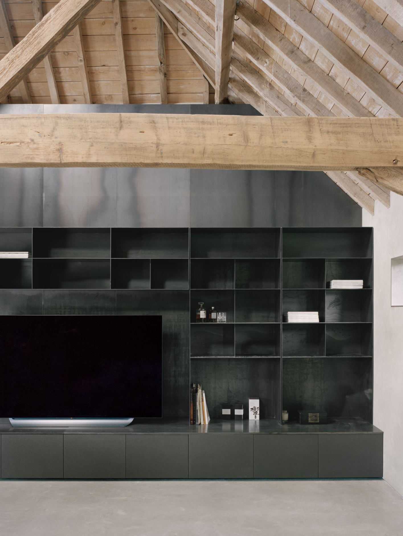 The union of old and new is echoed by the visual contrast between black and wooden elements