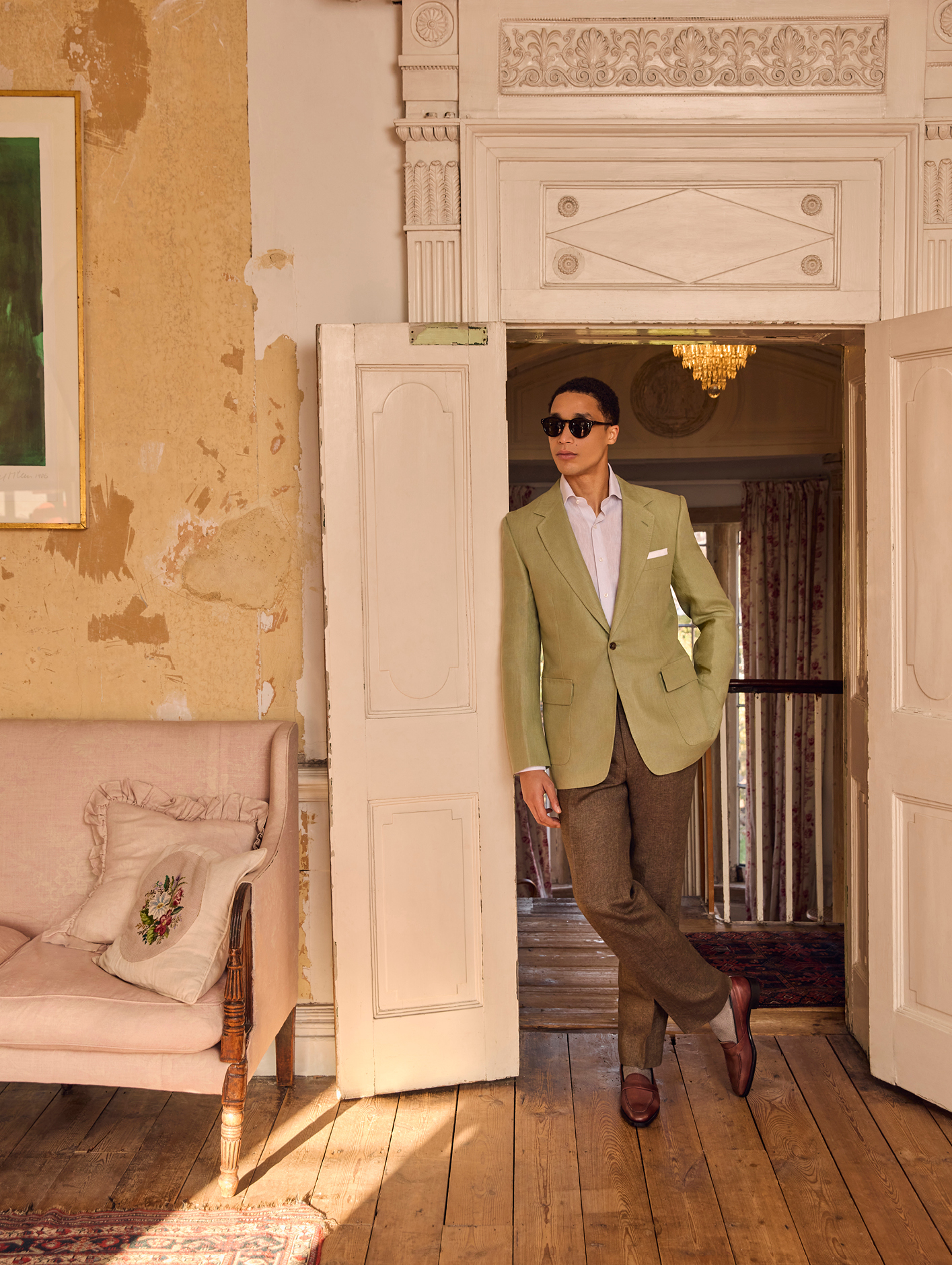 A model wearing sunglasses, a shirt, blazer, trousers and shoes from Huntsman spring/summer 2024