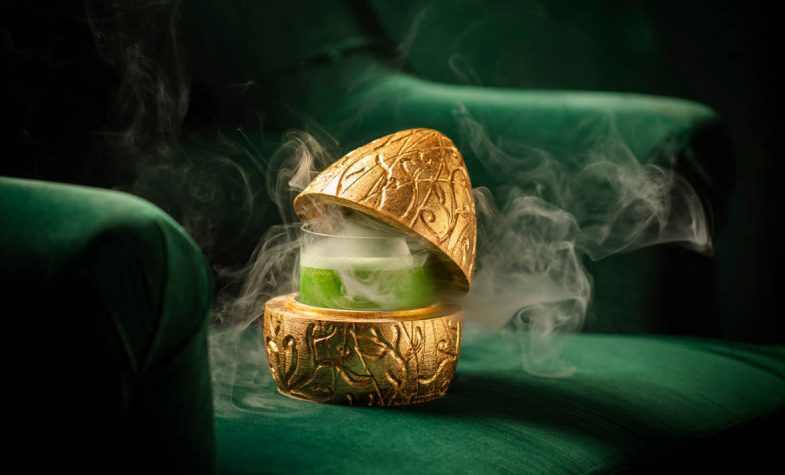 Head in the Clouds cocktail served in a smoking golden egg