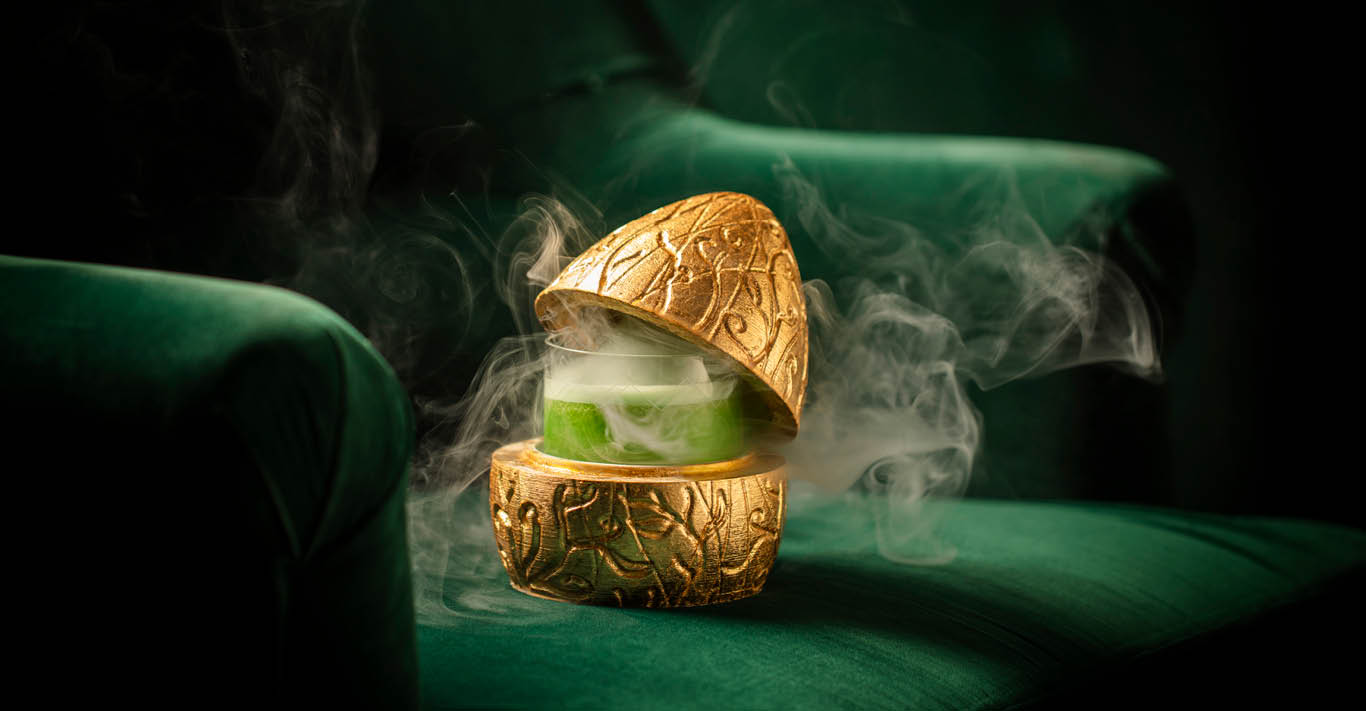 Head in the Clouds cocktail served in a smoking golden egg