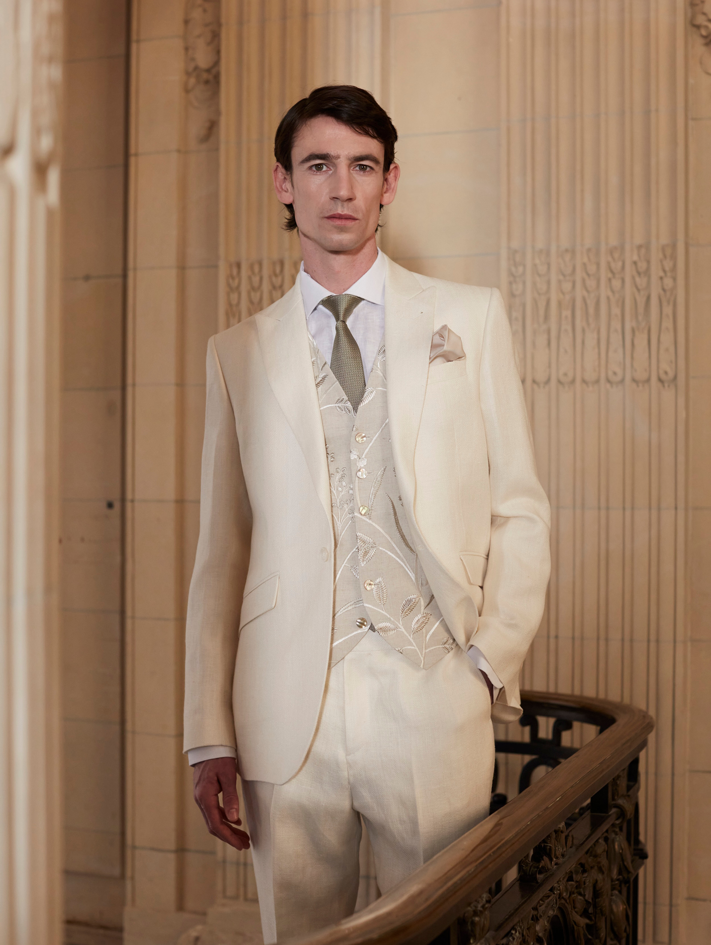 A model wears a white three-piece suit including the Stone Netherbury Single Breasted 6 Button Waistcoat from Favourbrook, £390