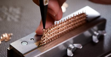 The Golden Ellipse’s rose-gold bracelet's individual links being set by hand