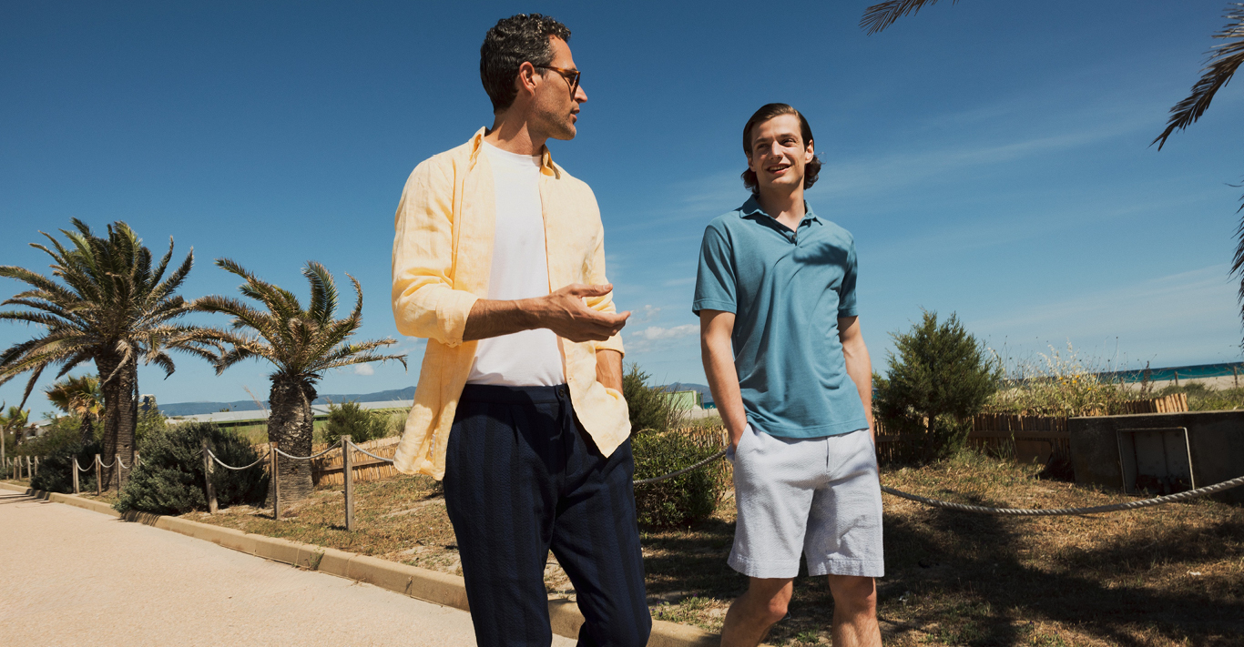 Two men wearing a shirt, £295, Glanshirt; T-shirt, £180, Zanone; trousers, £375, Incotex; polo shirt, £220, Zanone; shorts, £310, Incotex. All available at Slowear