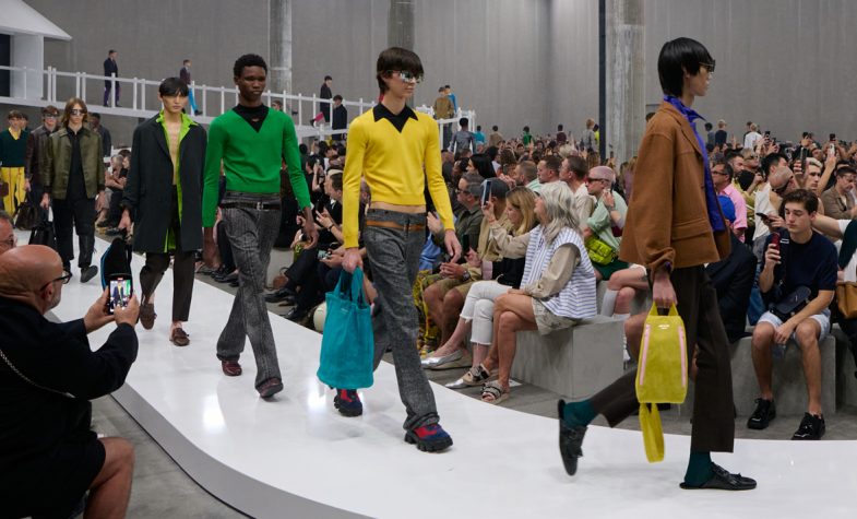 A procession of models on the catwalk at Milan Fashion Week wearing Prada SS24