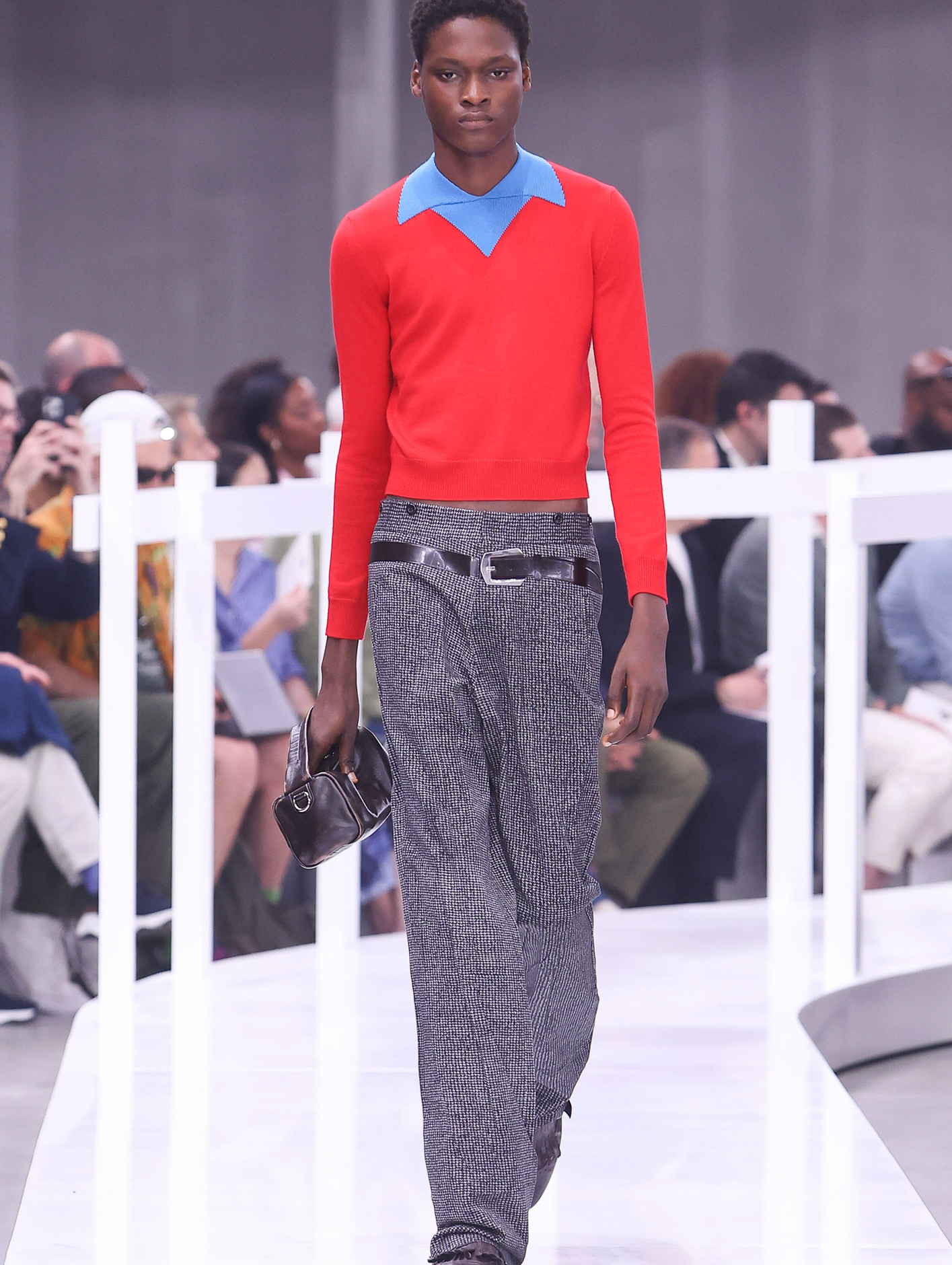 A model wearing high-waist tailored cotton trousers that look like tweed and feature a 3D-printed “belt"