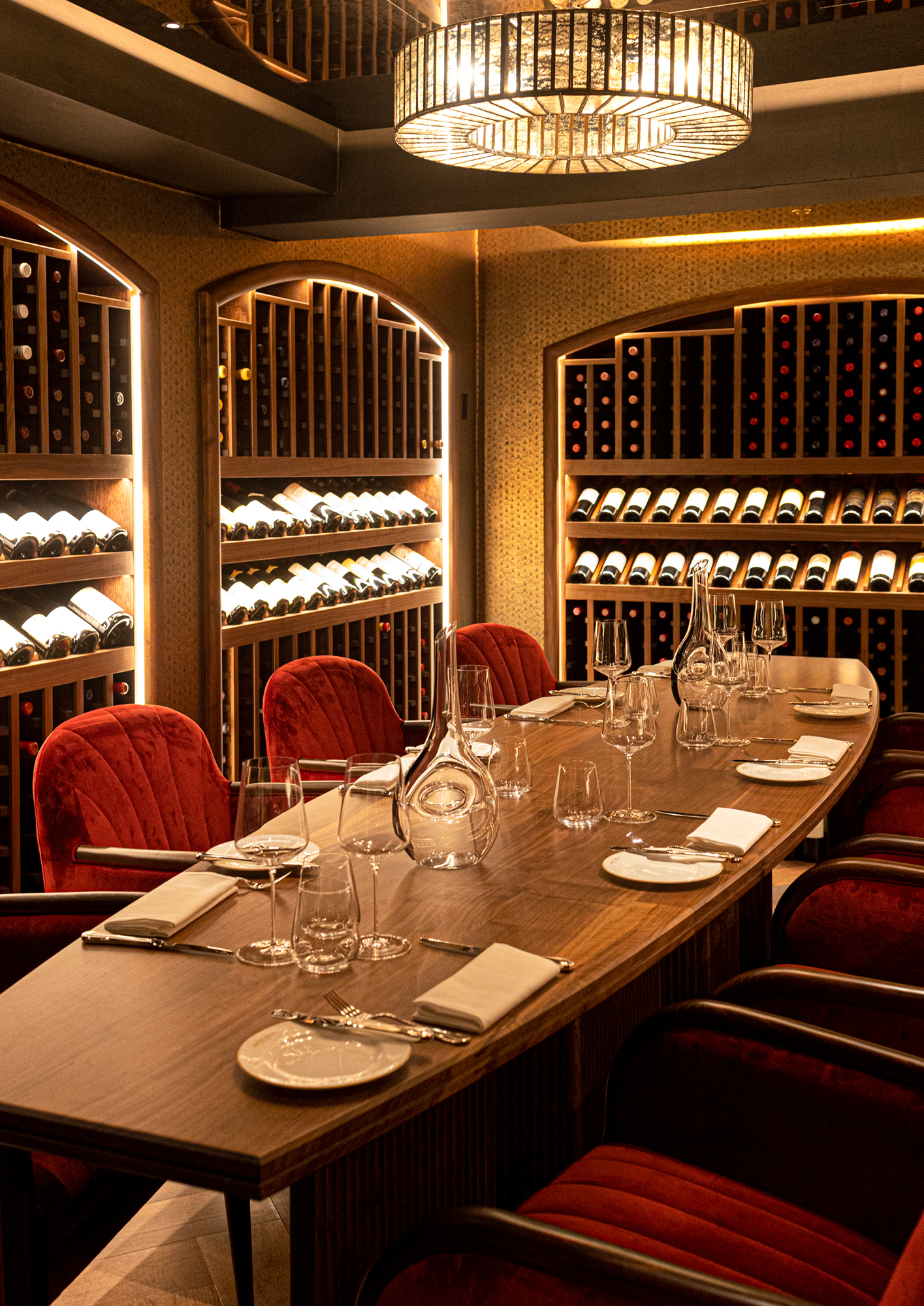 A dining table surrounded by shelves of wines