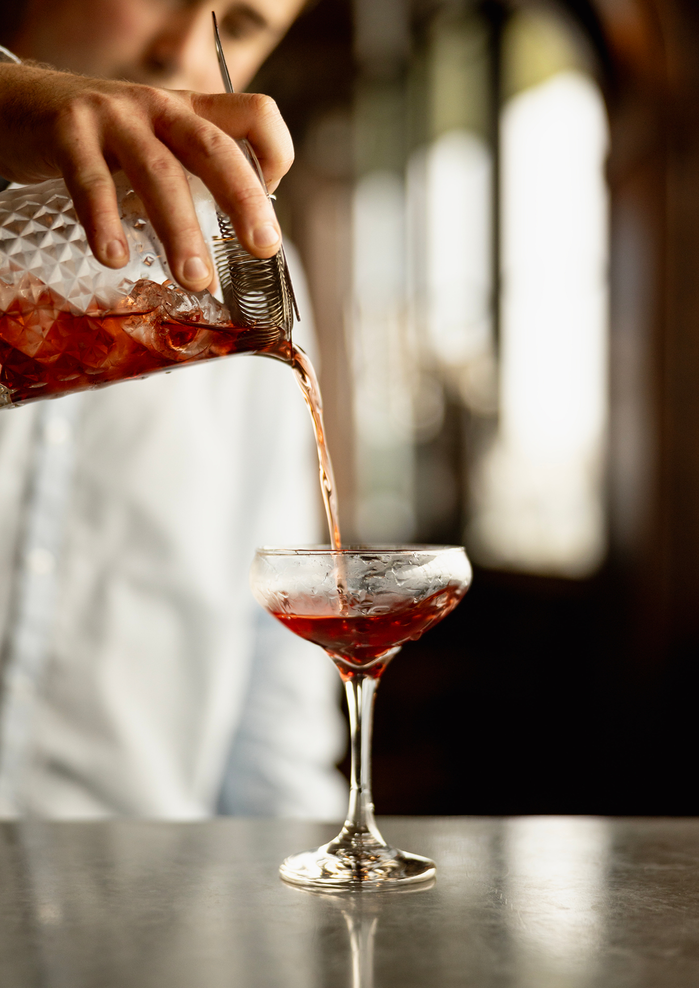 The Glendronach being strained into a cocktail