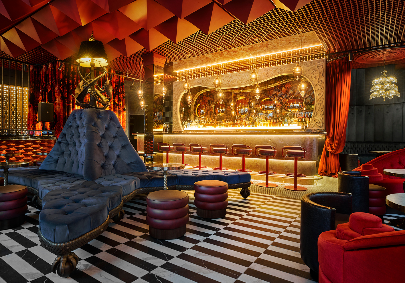 The interior design at Thirteen Ldn is marked by electric blue velvets, neon reds, and chequered flooring