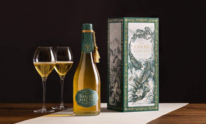 Two glasses filled with Sancho's Sixty Stone Mountain sparkling tea alongside the highly decorated box