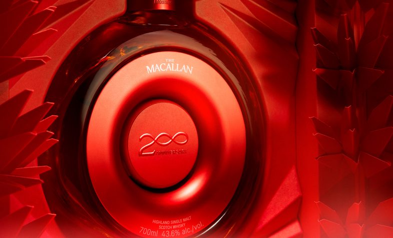 A round, gleaming red bottle of The Macallan's TIME:SPACE Mastery