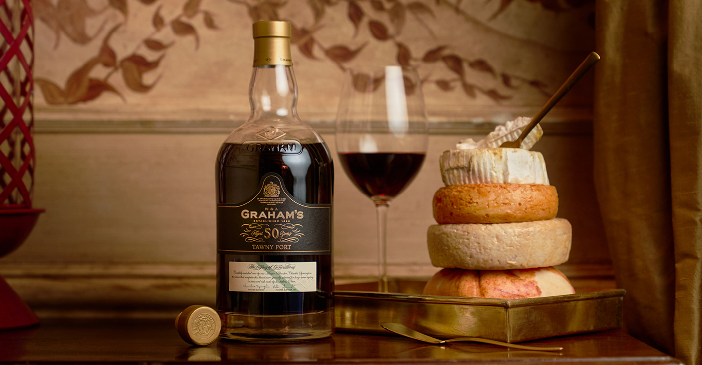 A glass and bottle of Graham's 50 Year Old Tawny Port